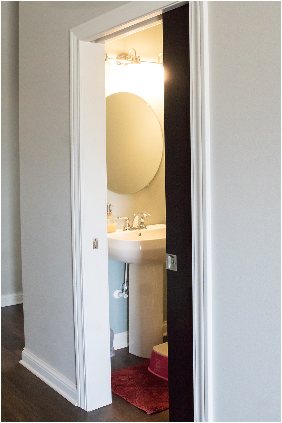 We designed this luxury half bath with a pocket door for ease of access Half Bath Design Ideas