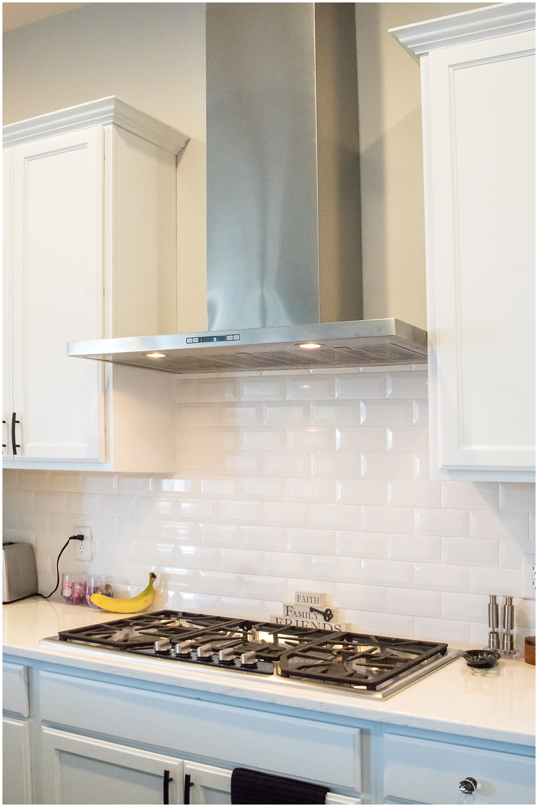 We used this stainless steel vent hood to add a modern look to this custom kitchen Custom Kitchen with Vent Hood
